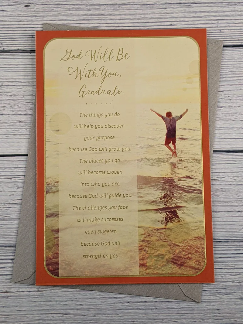 A religious graduation card with an image of a young man standing in the water at a beach.