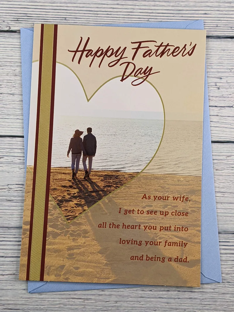 A Dayspring Father's Day greeting card for a husband, featuring a religious message and an image of a couple walking on a beach.