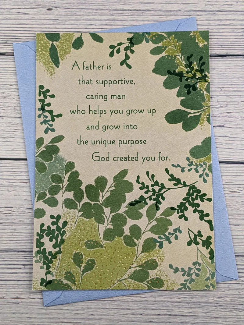 A Dayspring greeting card for Father's Day with a religious message and a tan cover with images of green leaves.