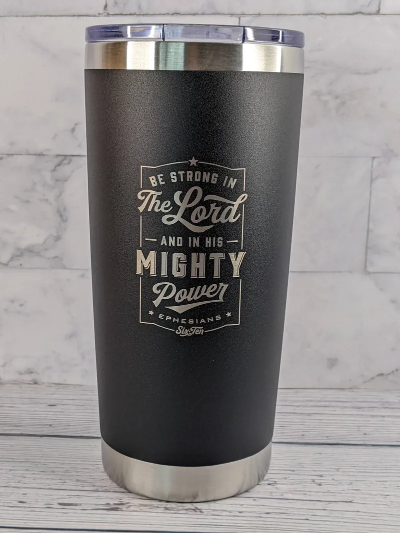 A black travel coffee mug tumbler made of stainless-steel, featuring a religious Scripture: Be strong in the Lord.
