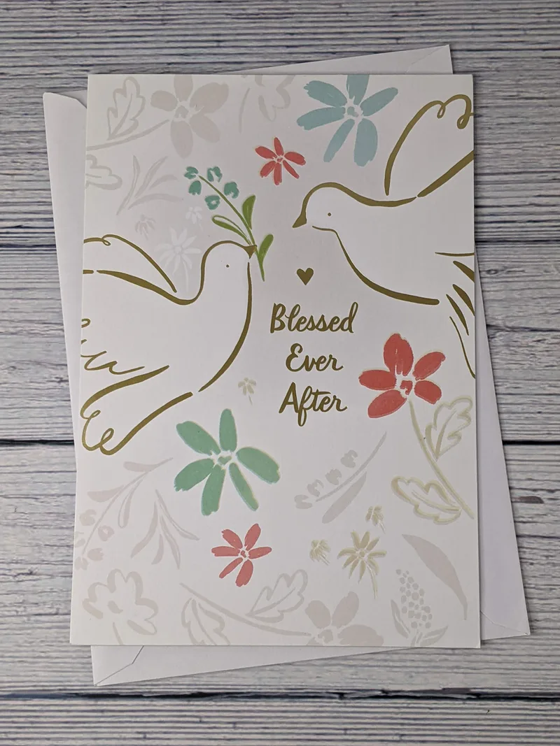 A religious wedding greeting card with an image of doves on the cover and the words, "Blessed Ever After."