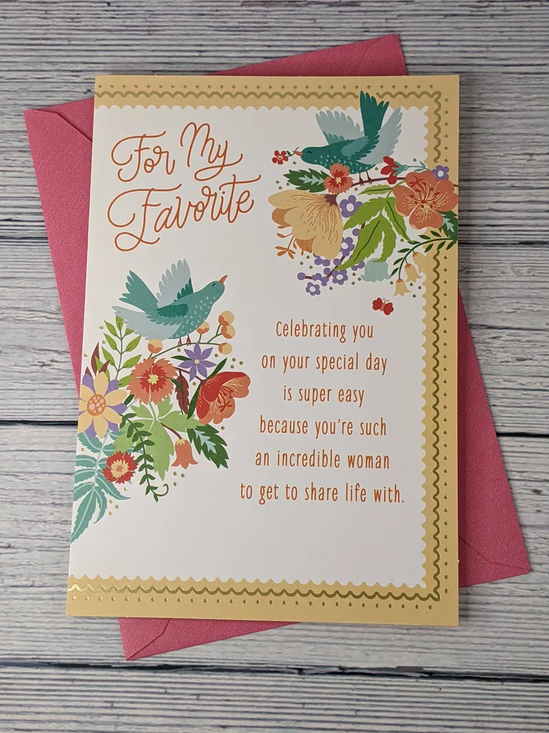 A birthday card for a wife from her husband. It has a sentimental greeting and images of birds and flowers.