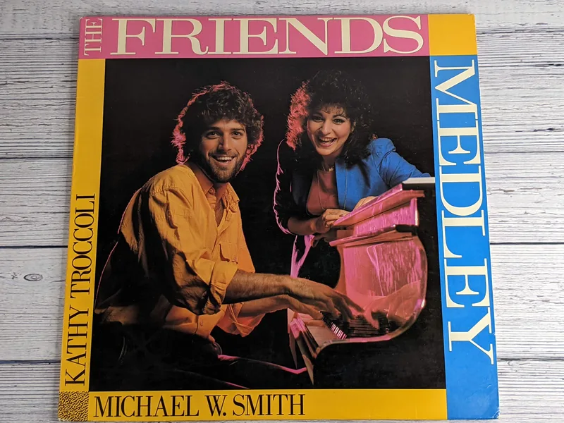 A vintage Christian Music Record Album, The Friends Medley, with an image of Michael W. Smith and Kathy Troccoli on the case from 1985.