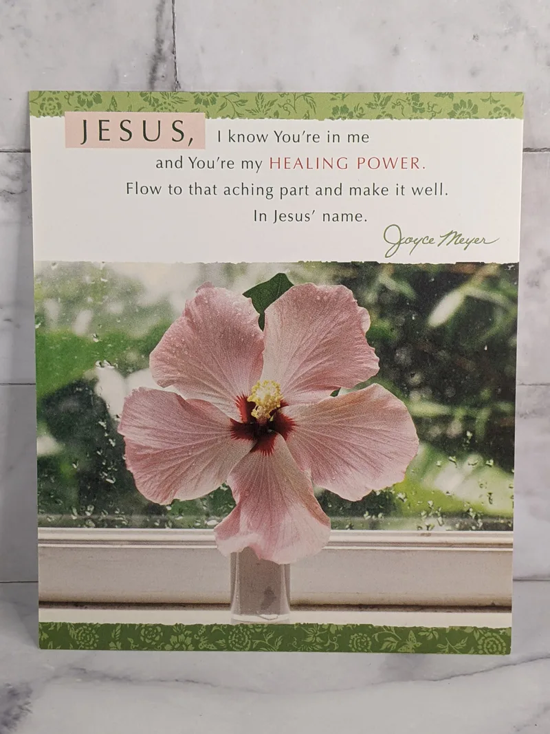 A Christian get-well greeting card by Joyce Meyer with an image of a pink flower on the front.