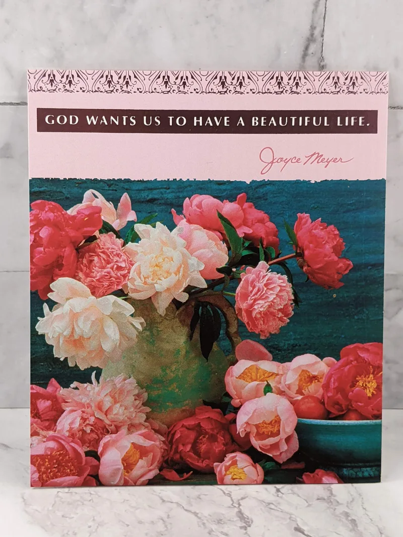 A pink birthday card for a woman with an image of a vase of flowers, and a metallic Christian sentiment.