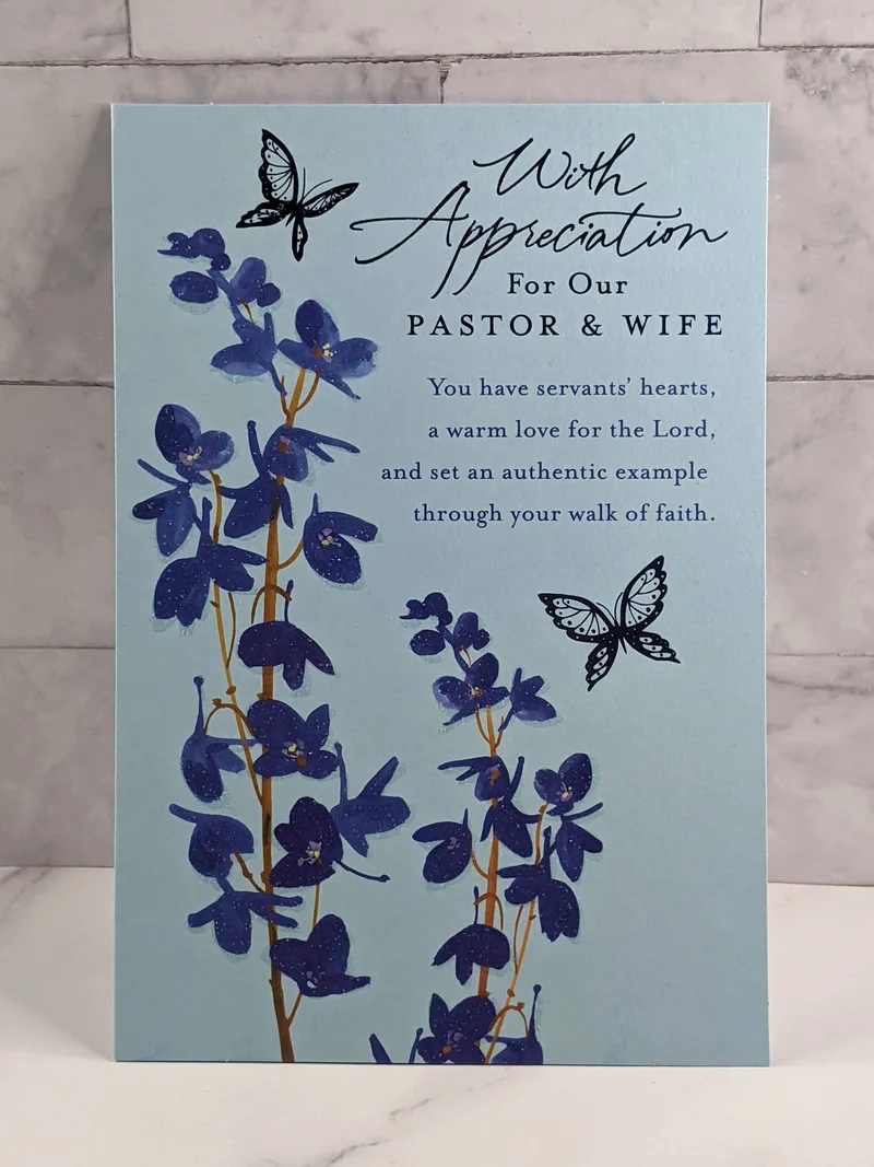A religious Pastor and Wife appreciation greeting card with a blue background and images of blue flowers and butterflies.