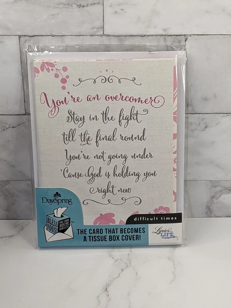 A religious greeting card that folds into a tissue box cover.  It has a message of encouragement for difficult times.