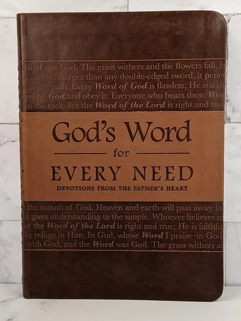 A book titled "God's Word for Every Need" with a brown faux leather cover